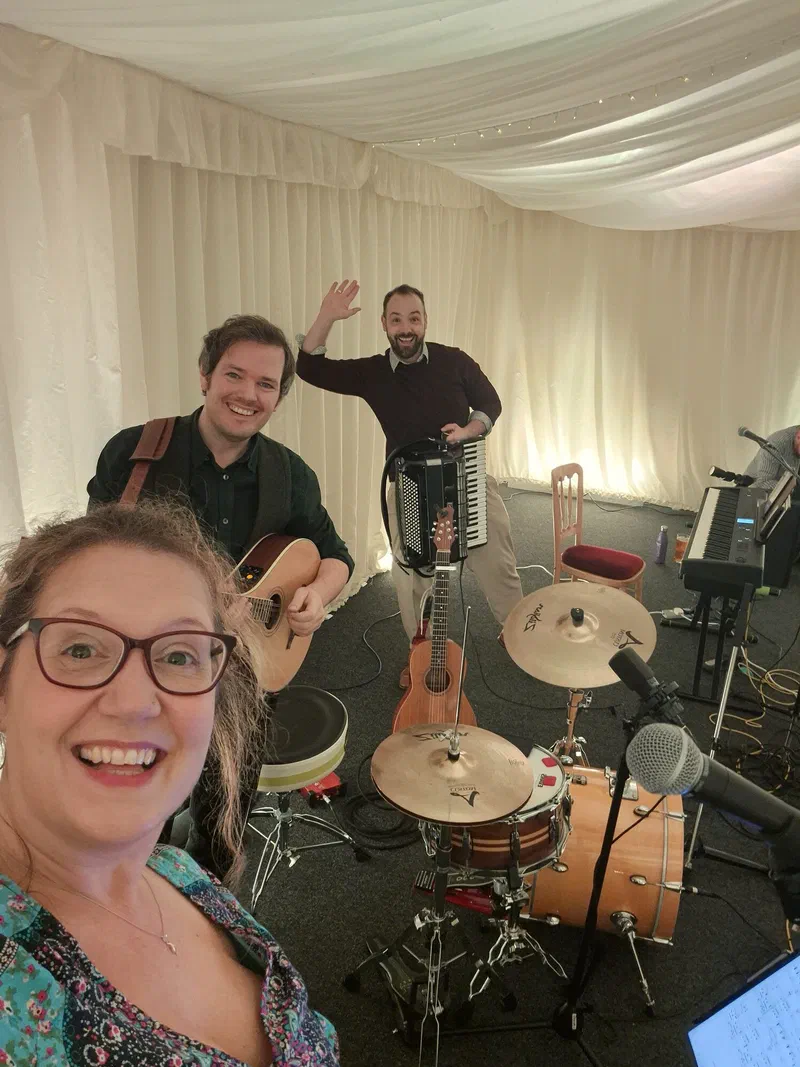 Sarah in the foreground with Tom and Dom setting up in a marquee
