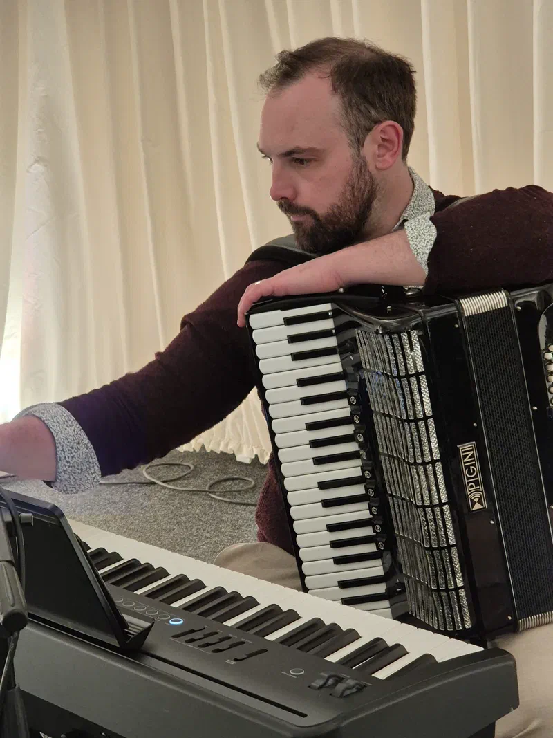 Dom with accordion and keyboard in a marquee