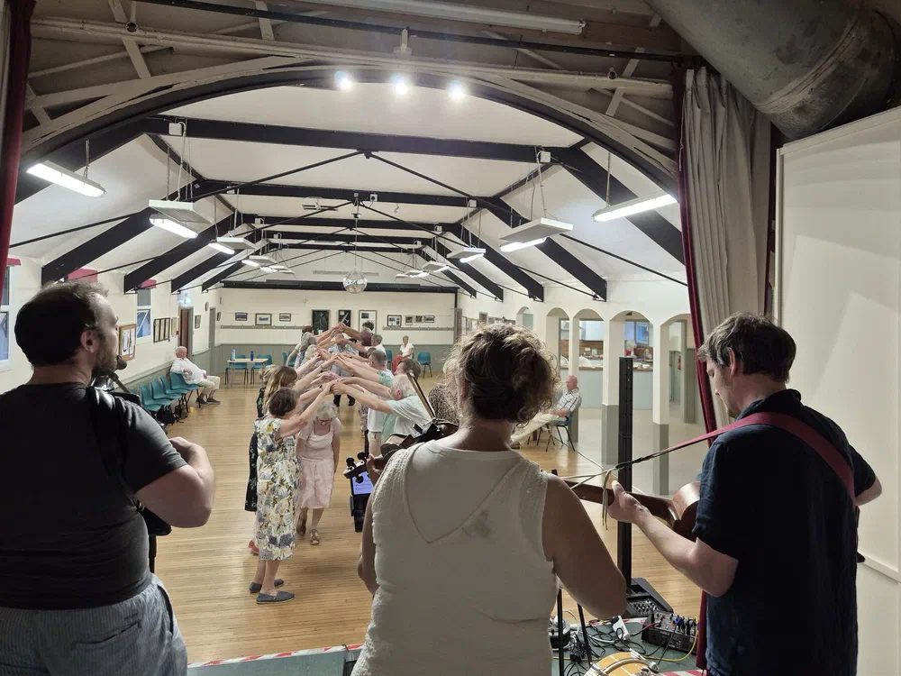 Dancers forming an arch as the band plays